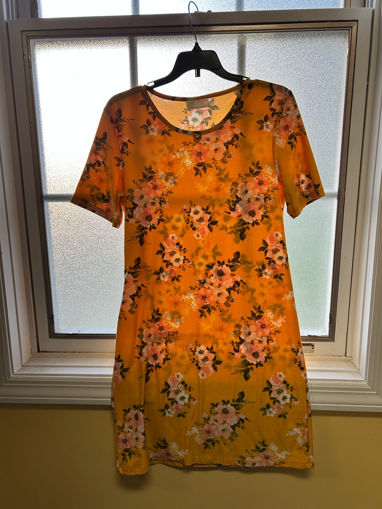 Expecting mom holding maternity wear